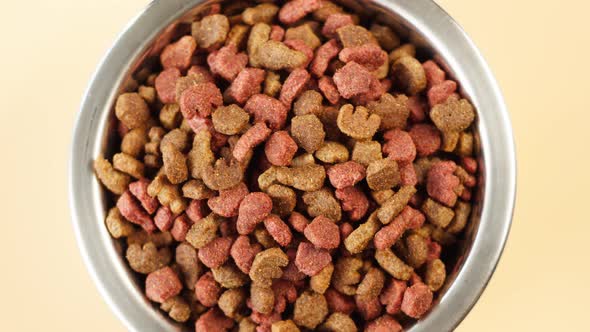 Dried Dog Food in Metal Bowl Top View Rotating alt