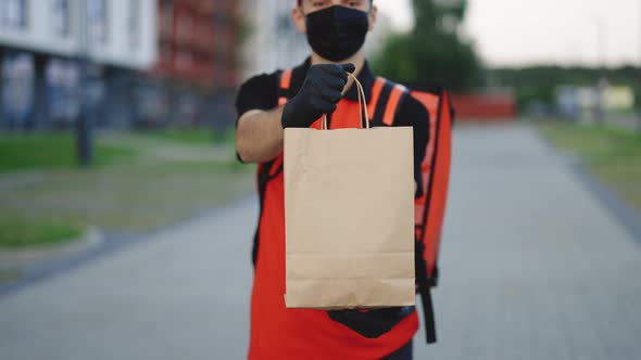 Handsome Courier Man Holding Paper Bag With Food at Street Outdoors Worker Grocery to House Door