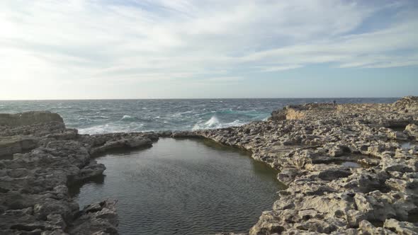 Stone Plateau near Azure Window in Gozo Island with Massive Waves Crashing in Shore