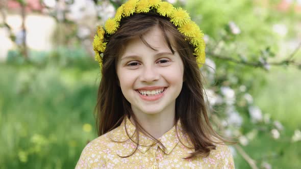 Portrait of Happy Smile Girl With a Wreath on Her Head in Summer