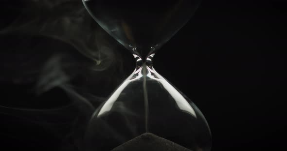 Beautiful smoke surrounding an hourglass alt
