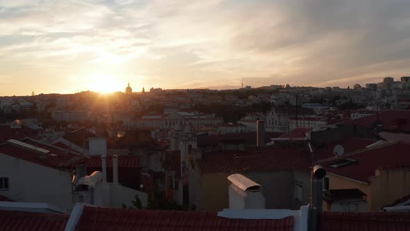 Slow Aerial Slider View of Red Rooftops with Colorful Old Houses and Churches in Urban City Center alt