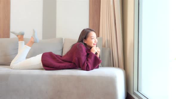 Asian woman sit on sofa and relax alt