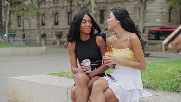Three Happy Young Multiracial Girlfriends Meeting in City on Weekend alt