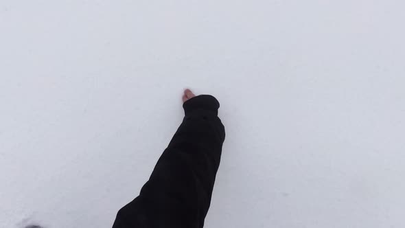 Drawing heart symbol on white fresh fluffy snow