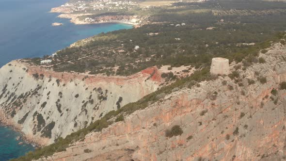 Ibiza pirate tower, aerial view over the old watch tower with the island of Ibiza in the background. alt