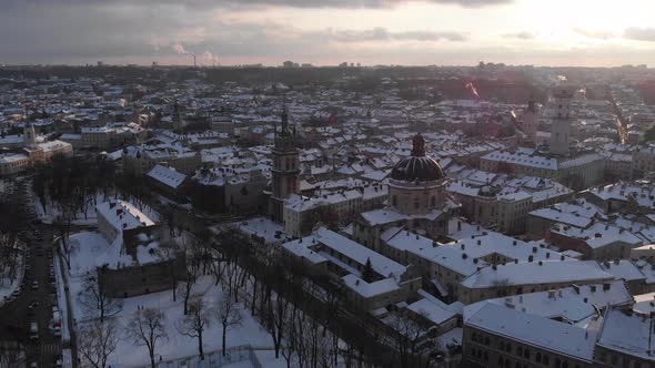 Aerial shot of Old City Lviv cowered by snow with churches and cathedrals.