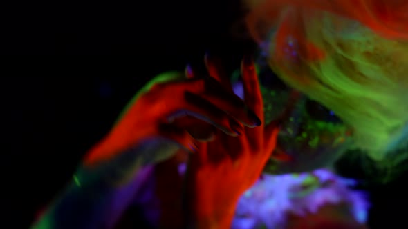 Flourescent Makeup and Body Art By Glowing Paints in Darkness Silhouette of Woman in UV Lights alt