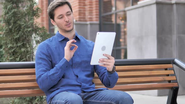 Online Video Chat on Tablet by Young Man alt