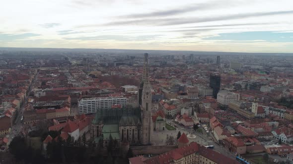 Wide aerial rise over central Zagreb. Shot at sunset during a cloudy day. alt