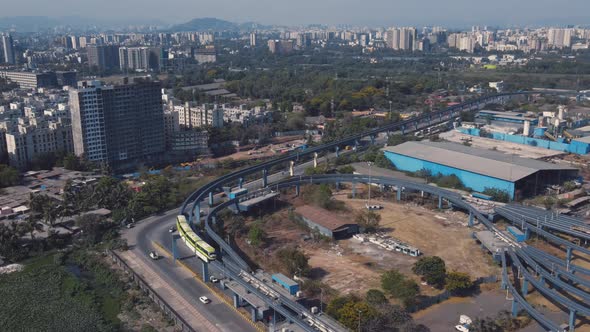 Aerial view and skyline of Mumbai city. Drone shot of MonoRail passing over slum.