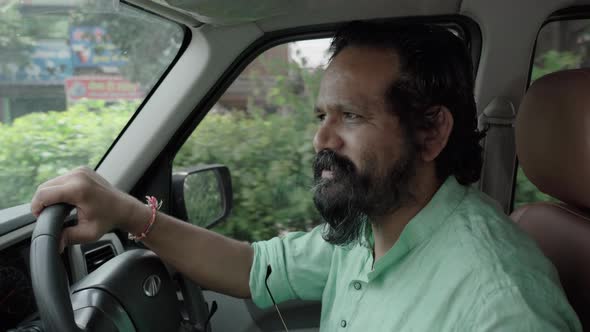 Indian Man with Googles and Bear Talking Driving Car