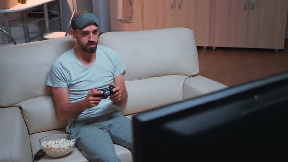Player Man Holding Wireless Controller While Playing Videogames alt