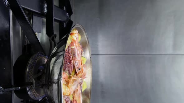 Cataplan with Seafood and Vegetables on a Gas Stove alt