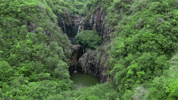 Camera is Flying Above Waterfall in Tropical Forest alt