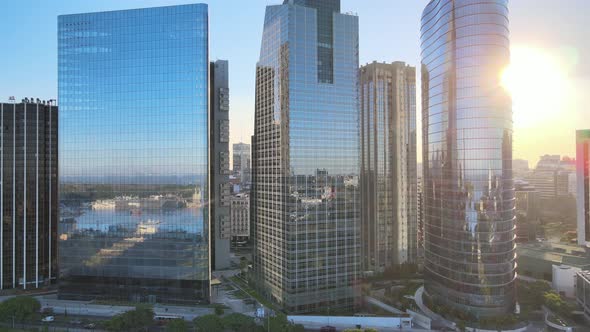 Aerial dolly right window glass skyscrapers reflecting Puerto Madero docks at golden hour, Buenos Ai alt