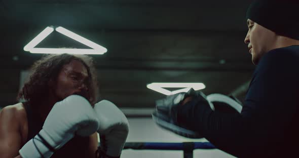 Black Pugilist is Punching Targets Pads for Boxing Training on Coach Hands  Prores alt