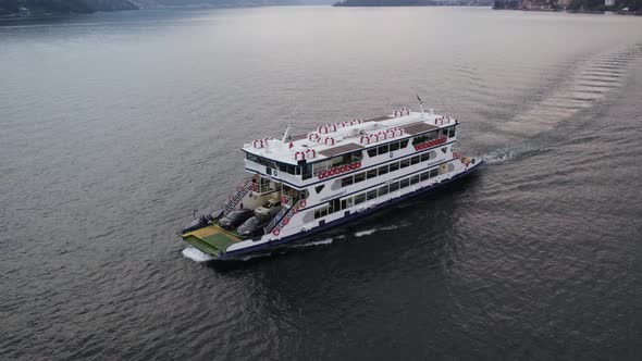 Ferry transporting cars to Bellagio on scenic Lake Como; aerial shot alt