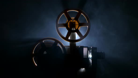 Fast Rewind the Film on the Projector. Side View alt