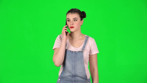 Girl Talking for Mobile Phone, Very Shocked Then Rejoice on Green Screen alt