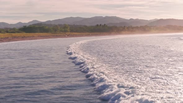 Pelicans flying at Playa Buena Vista Beach at sunset, Costa Rica, Aerial drone view alt