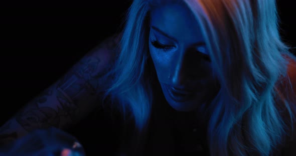 Close up of a young female tattoo artist during her work in studio. BMPCC 4K alt