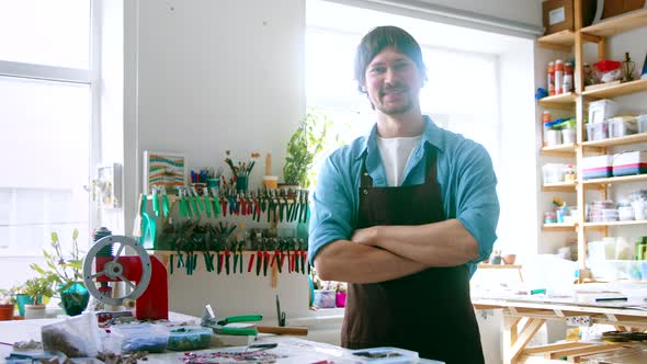 Smiling young man looking at the camera, slow motion view alt