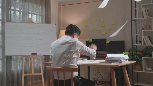 Back View Of Pressure Asian Man Throw Away The Paper While Working Hard With Documents At The Office alt