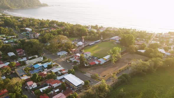 Stunning, golden sunset over the beach and seaside town of Jaco on the Pacific Coast of Costa Rica. alt