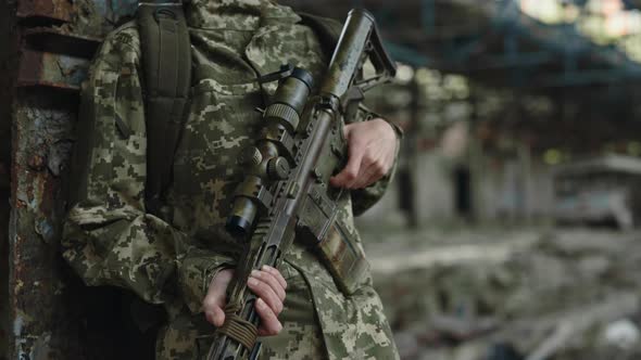 Female Soldier with Gun Hiding in Building During Mission alt