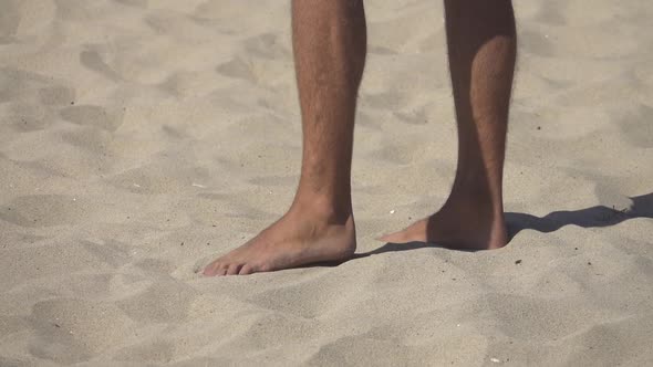 Detail of a mans feet while playing pro beach volleyball. alt