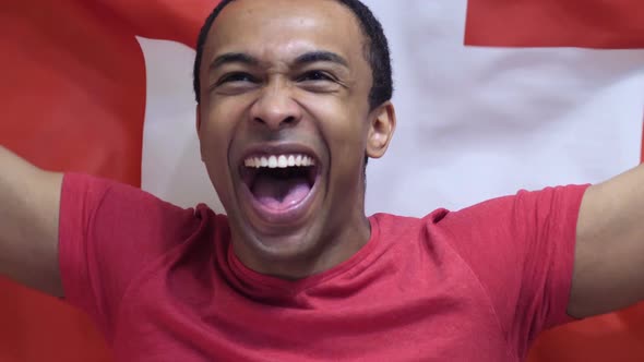 Swiss Fan Celebrates Holding the Flag of Switzerland alt