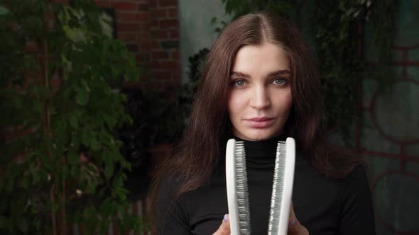 Beautiful Soulful Woman with Long Hair Reveals a Set of Sadhu Boards Near Her Face Yoga Practice alt