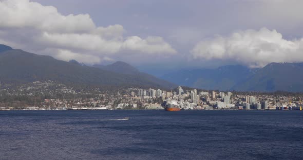 A fast boat crossing in front of North Vancouver alt