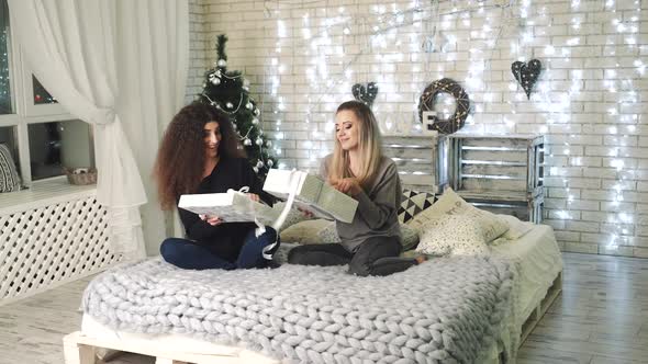 Women with Christmas gift boxes. alt