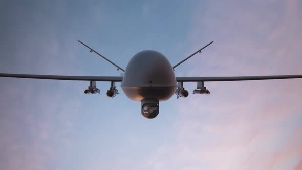 Military predator drone flying at sunset. Armed intelligent unmanned vehicle.