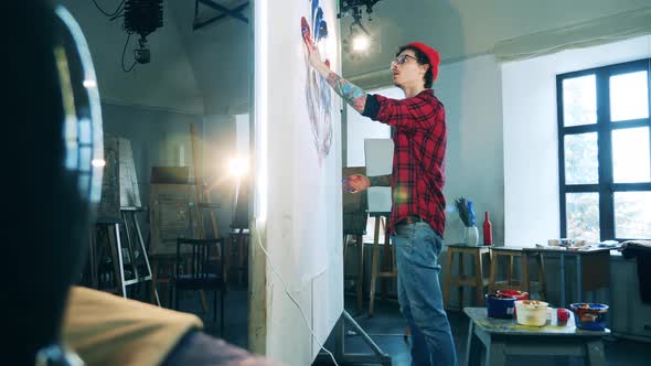 A Picture is Being Created By a Male Artist with Tattoos alt