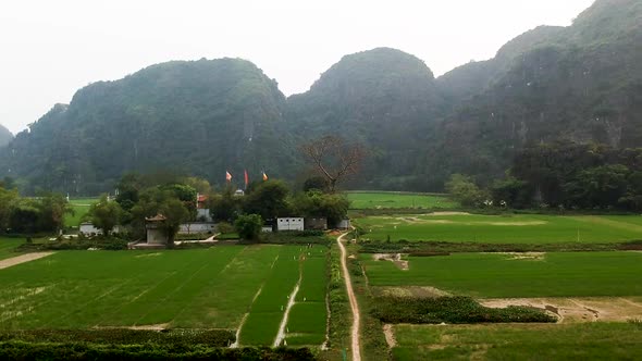 Aerial ascend over Thai Vi Temple in Vietnamese Countryside Tam Coc, Ninh Binh, Vietnam alt