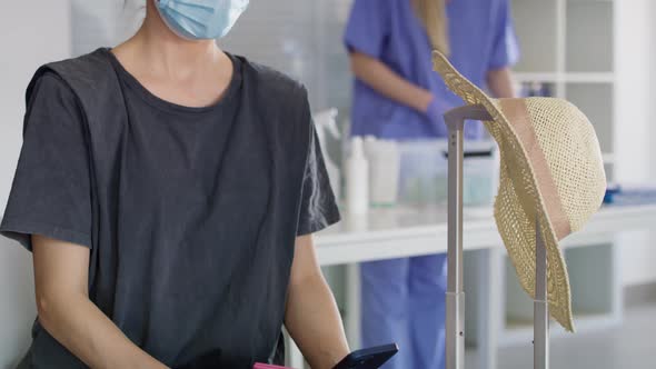 Tilt up video of woman holding digital covid-19 vaccine passport. Shot with RED helium camera in 8K. alt