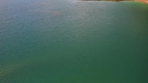 Drone View of the Turquoise Lake Formed As a Result of Mining Waste alt