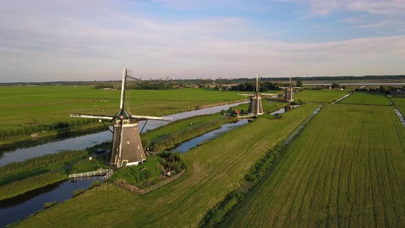 Countryside Scenery With Rustic Windmills On Meadow Landscape Against Blue Cloudy Sky In The Hague alt