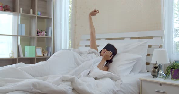 Asian young woman wake up late with alarm clock