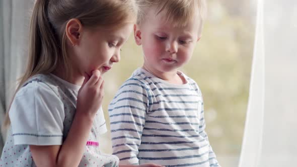 Little Siblings Playing on Tablet