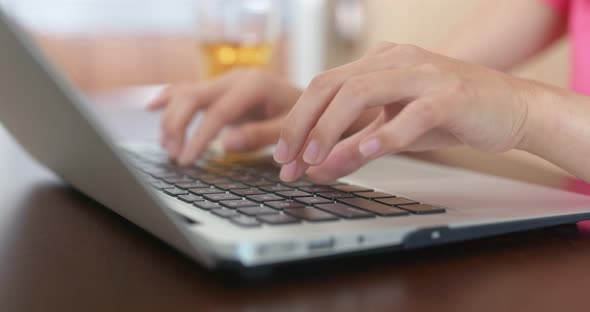 Woman type on computer at home alt