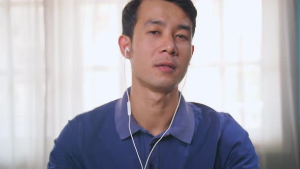 Asian Man Talking To Camera alt