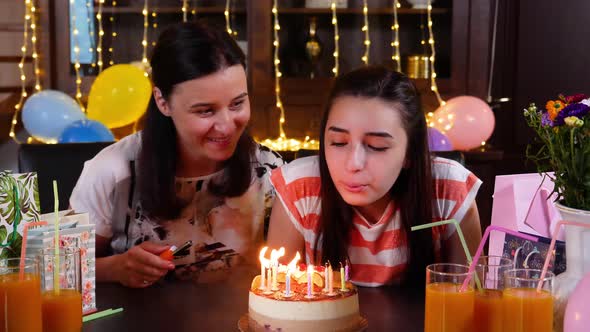 Happy Teen Girl and Mother with Birthday Cake