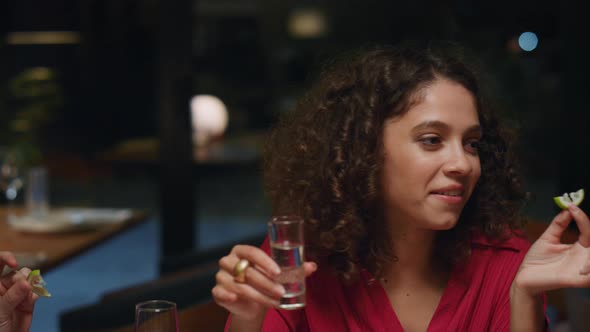 African American Girl Drinking Shot on Friends Meeting at Fancy Restaurant Bar alt