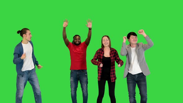Multiethnic Group of Young Friends Dancing on a Green Screen Chroma Key