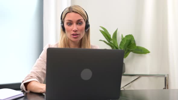 Charming Business Woman Teacher Online Tutor Wearing Headset Using Laptop