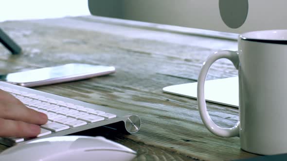 A Caucasian Male Typing on a Wireless Keyboard 03 alt